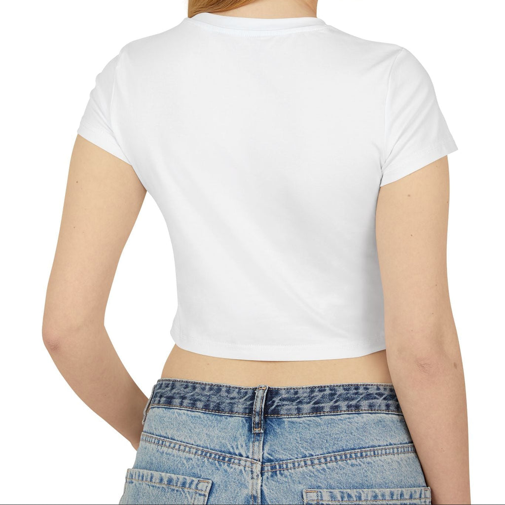 Woman wearing a white crop top and blue jeans on a white background