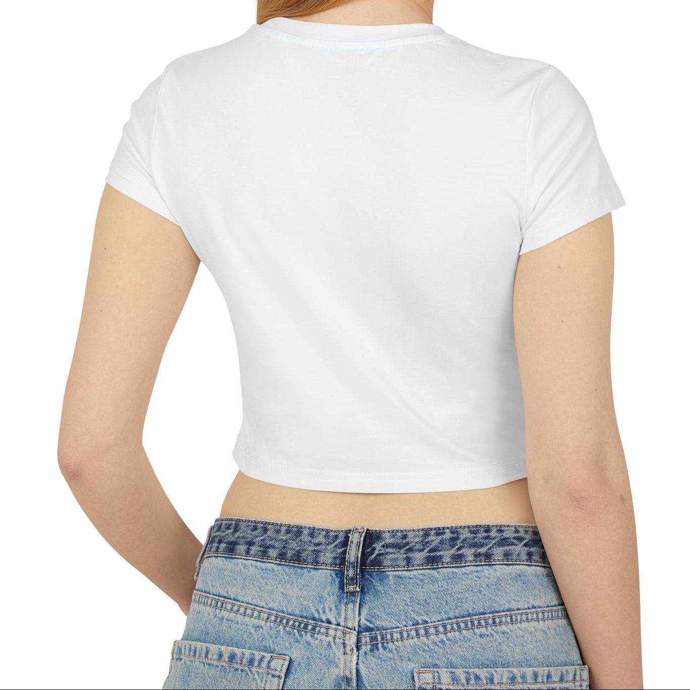 Woman wearing a white crop top and blue jeans on a white background