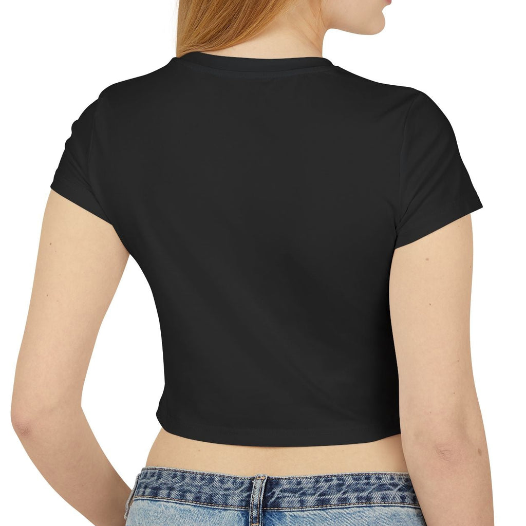 Person wearing a black crop top and blue jeans on a white background