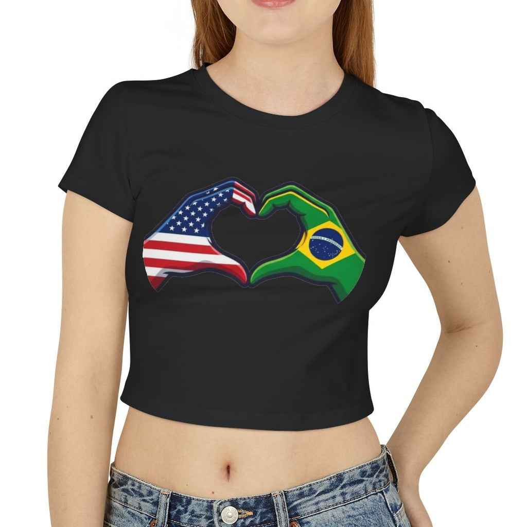 Woman wearing a black t-shirt with a design of two fists, one with American flag colors and the other with Brazilian flag colors, on a white background.