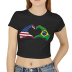 Woman wearing a black t-shirt with a design of two fists, one with American flag colors and the other with Brazilian flag colors, on a white background.