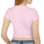Woman wearing a pink crop top and blue jeans on a white background