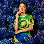 Woman wearing a green and blue patterned dress with floral background