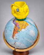 Can Drip yellow and green 3D-printed hoodie can holder displayed above a globe with Brazil centered