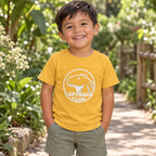 AI-created lifestyle mockup: Heather Yellow Gold Capybara Club toddler tee in a garden.