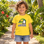 AI-created lifestyle mockup of a toddler wearing the Yellow Brasil toucan tee on a sunny garden path.